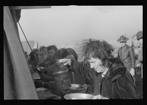 Woman at mealtime in the camp for white flood refugees, Forrest City, Arkansas