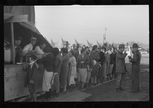 Untitled photo, possibly related to: Line of flood refugees at mealtime in camp for white flood refugees at Forrest City, Arkansas