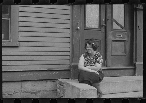 Untitled photo, possibly related to: Woman sitting on step, Manchester, New Hampshire