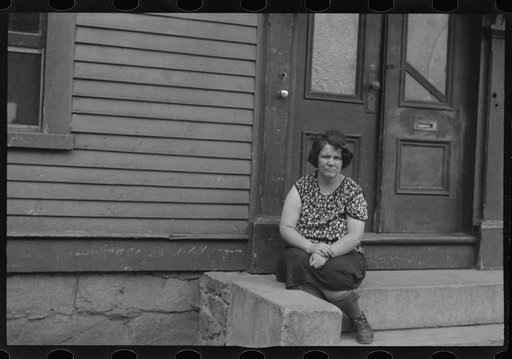 Woman sitting on step, Manchester, New Hampshire