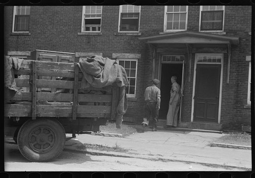 Untitled photo, possibly related to: Loading a bureau into truck, Manchester, New Hampshire