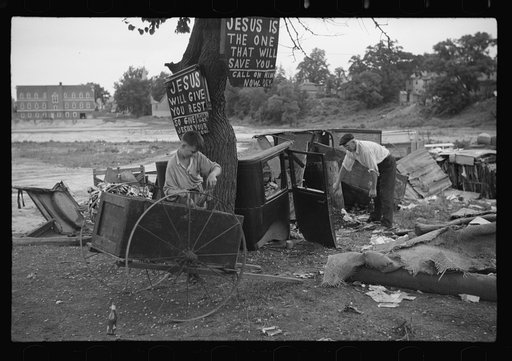 Untitled photo, possibly related to: Buddy Sheppard and his father, part-time agricultural workers in Bridgetown, New Jersey, raking junk pile for old metal and bottles to sell. During the off-seasons these people must find all manner of strange occupations to round out an inadequate relief diet
