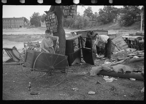 Untitled photo, possibly related to: Buddy Sheppard and his father, part-time agricultural workers in Bridgetown, New Jersey, raking junk pile for old metal and bottles to sell. During the off-seasons these people must find all manner of strange occupations to round out an inadequate relief diet