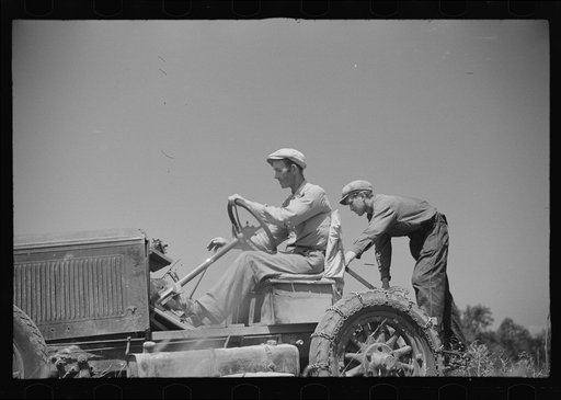 Untitled photo, possibly related to: Luke Weldon, small farmer, and his son using ancient Buick (transformed by cutting down the chassis) as improvised tractor. Automobile bought in second hand car lot. Cost fifteen dollars. New Bridgetown, New Jersey