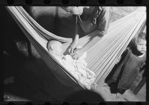 Baby asleep in hammock. The hammock saves space in a shack already overcrowded. Puerta de Tierra, San Juan, Puerto Rico