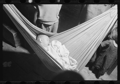 Untitled photo, possibly related to: Baby asleep in hammock. The hammock saves space in a shack already overcrowded. Puerta de Tierra, San Juan, Puerto Rico