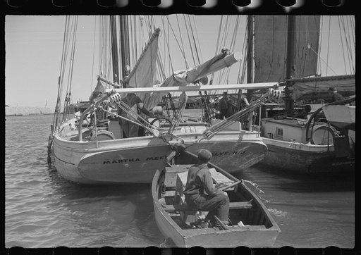 Untitled photo, possibly related to: Aboard a trap fishing boat poling out. The trap boat is poled out of the trap by hand. The engine is not started until the propeller is clear of any danger of fouling the net. Provincetown, Massachusetts
