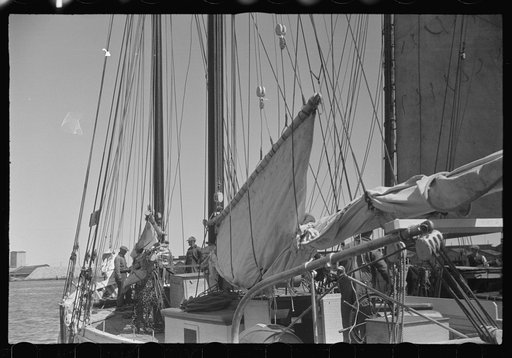 Untitled photo, possibly related to: Aboard a trap fishing boat poling out. The trap boat is poled out of the trap by hand. The engine is not started until the propeller is clear of any danger of fouling the net. Provincetown, Massachusetts