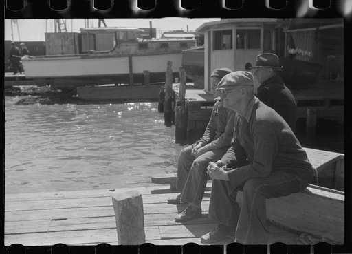 Untitled photo, possibly related to: Summer residents watch the tourist boat arrive from Boston, Provincetown, Massachusetts