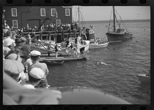 Untitled photo, possibly related to: Summer residents watch the tourist boat arrive from Boston, Provincetown, Massachusetts
