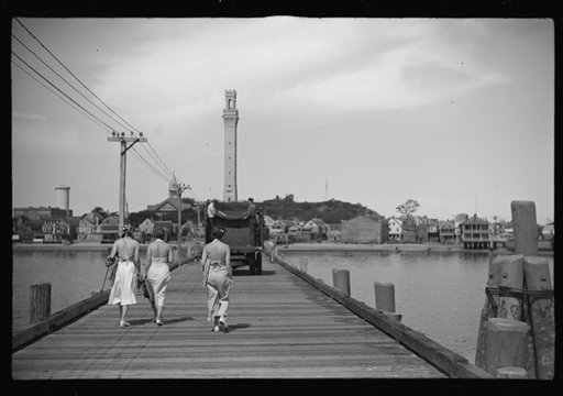 Untitled photo, possibly related to: Summer residents watch the tourist boat arrive from Boston, Provincetown, Massachusetts