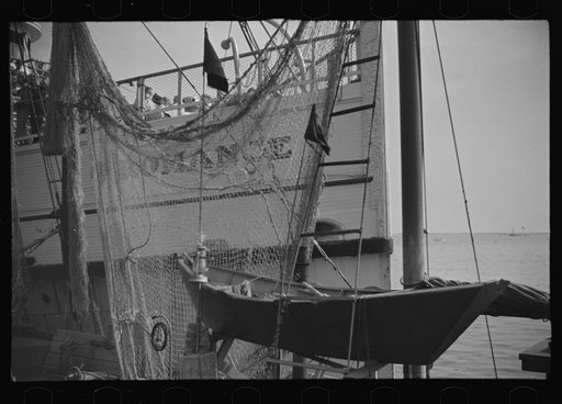 Untitled photo, possibly related to: The economy of a town: fishing and the tourist trade. A fishing boat in front of the S.S. "Romance," a tourist boat which used to ply between Boston and Provincetown and has since sunk in Boston Harbor. Provincetown, Massachusetts