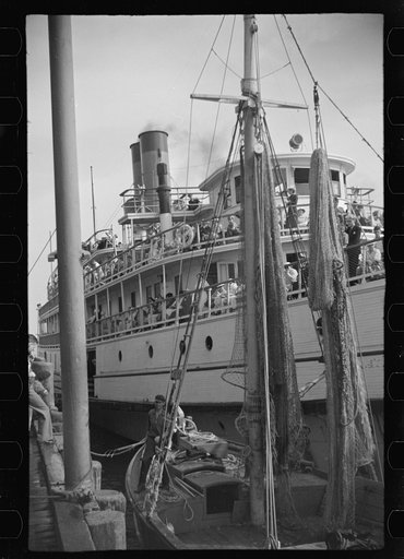 Untitled photo, possibly related to: The economy of a town: fishing and the tourist trade. A fishing boat in front of the S.S. "Romance," a tourist boat which used to ply between Boston and Provincetown and has since sunk in Boston Harbor. Provincetown, Massachusetts
