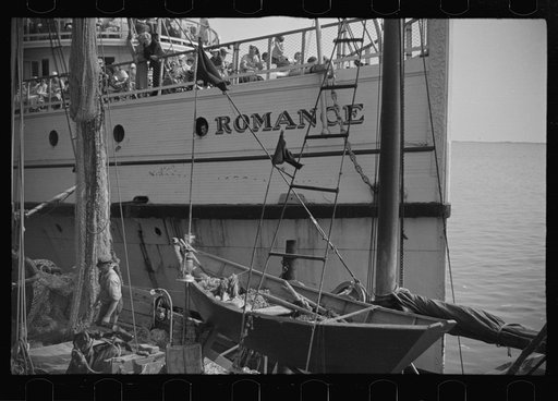 Untitled photo, possibly related to: The economy of a town: fishing and the tourist trade. A fishing boat in front of the S.S. "Romance," a tourist boat which used to ply between Boston and Provincetown and has since sunk in Boston Harbor. Provincetown, Massachusetts