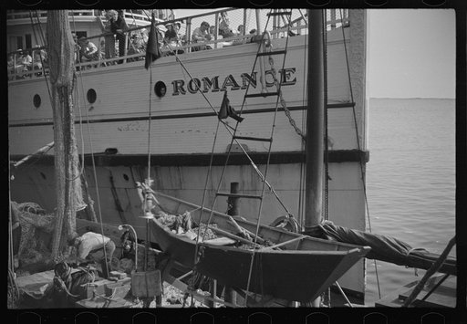 Untitled photo, possibly related to: The economy of a town: fishing and the tourist trade. A fishing boat in front of the S.S. "Romance," a tourist boat which used to ply between Boston and Provincetown and has since sunk in Boston Harbor. Provincetown, Massachusetts
