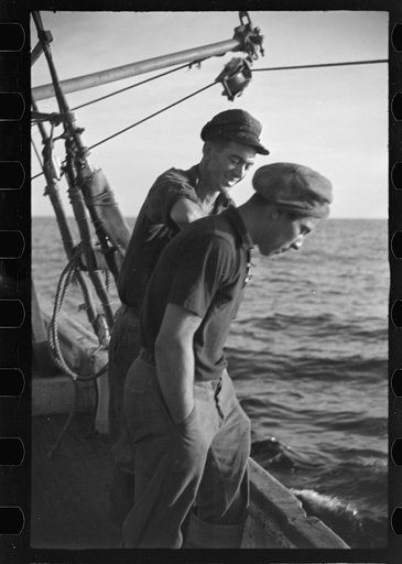 Untitled photo, possibly related to: Aboard a trawler (locally called a dragger). The power-driven winch lets out the starboard net. While over fishing grounds one of two nets is constantly in the water, dragging along the bottom. Boats are powerful, diesel-engined, between forty and seventy-five fe