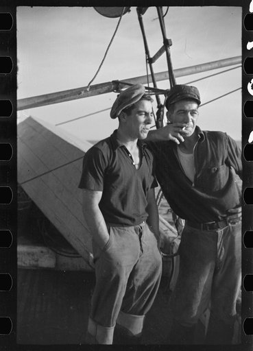 Untitled photo, possibly related to: Aboard a trawler (locally called a dragger). The power-driven winch lets out the starboard net. While over fishing grounds one of two nets is constantly in the water, dragging along the bottom. Boats are powerful, diesel-engined, between forty and seventy-five fe