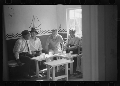 Fishermen and tourists mingle in tourist bar, Provincetown, Massachusetts
