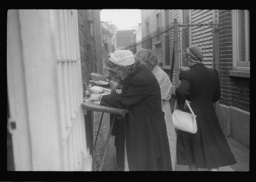 Untitled photo, possibly related to: Postcards to friends. Souvenir shops provide an outdoor desk for tourists who want to write "wish you were here." Provincetown, Massachusetts
