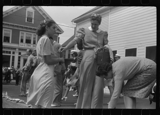 Tourists, fresh off the boat from Boston. With only two hours in town, they buy seashells dinners, trinkets and rides on the sight seeing bus. Provincetown, Massachusetts