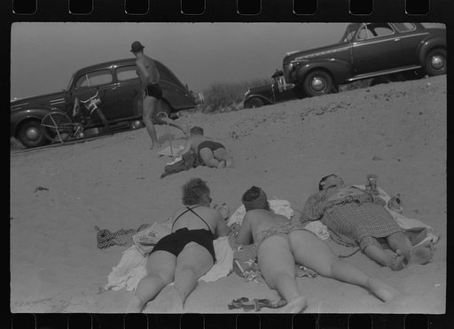 Untitled photo, possibly related to: Beach scene at "New Beach," the most popular beach near Provincetown. Regular bus service makes this beach easily available; lack of bath houses causes a great deal of picturesque dressing and undressing in and behind parked cars. Provincetown, Massachusetts