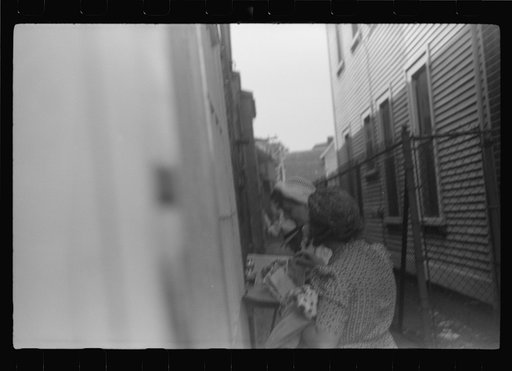Untitled photo, possibly related to: Postcards to friends. Souvenir shops provide an outdoor desk for tourists who want to write "wish you were here." Provincetown, Massachusetts