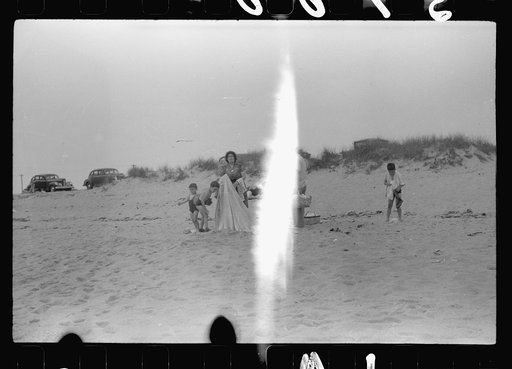 Untitled photo, possibly related to: Beach scene at "New Beach," the most popular beach near Provincetown. Regular bus service makes this beach easily available; lack of bath houses causes a great deal of picturesque dressing and undressing in and behind parked cars. Provincetown, Massachusetts
