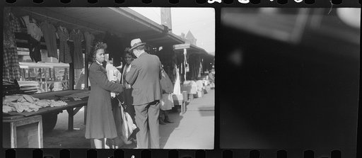 Untitled photo, possibly related to: Negroes making purchases from white proprietor of street clothing stall, Black Belt, Chicago, Illinois