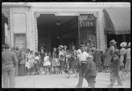 Children in front of moving picture theater, Easter Sunday matinee, Black Belt, Chicago, Illinois