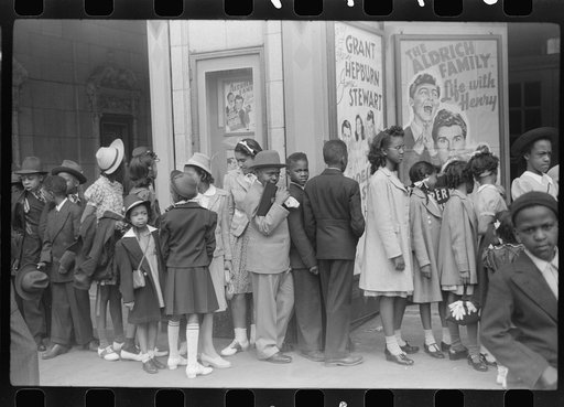 Untitled photo, possibly related to: Children in front of moving picture theater, Easter Sunday matinee, Black Belt, Chicago, Illinois
