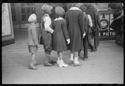 Untitled photo, possibly related to: Children in front of moving picture theater, Easter Sunday matinee, Black Belt, Chicago, Illinois