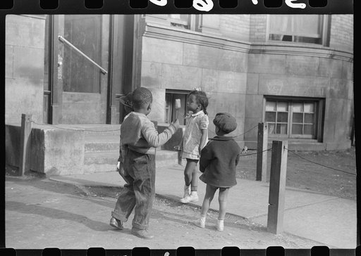 Untitled photo, possibly related to: Children in front of apartment buildings in one of the better neighborhoods in the Black Belt, Chicago, Illinois