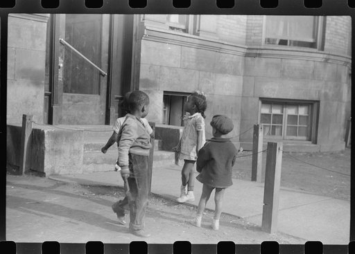 Untitled photo, possibly related to: Children in front of apartment buildings in one of the better neighborhoods in the Black Belt, Chicago, Illinois