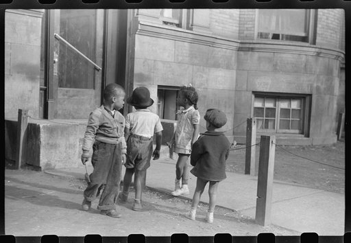 Untitled photo, possibly related to: Children in front of apartment buildings in one of the better neighborhoods in the Black Belt, Chicago, Illinois