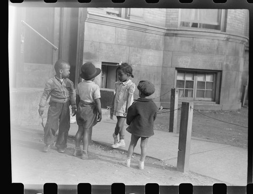 Untitled photo, possibly related to: Children in front of apartment buildings in one of the better neighborhoods in the Black Belt, Chicago, Illinois