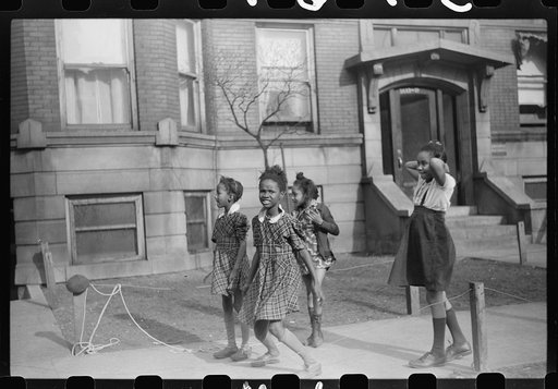 Untitled photo, possibly related to: Children in front of apartment buildings in one of the better neighborhoods in the Black Belt, Chicago, Illinois