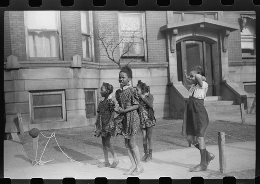 Untitled photo, possibly related to: Children in front of apartment buildings in one of the better neighborhoods in the Black Belt, Chicago, Illinois
