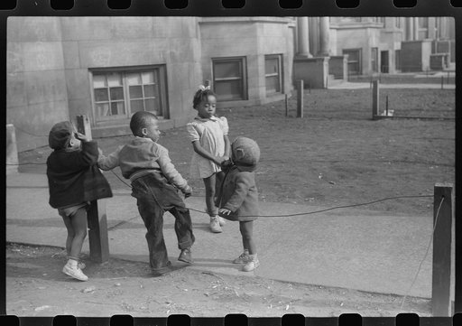 Untitled photo, possibly related to: Children in front of apartment buildings in one of the better neighborhoods in the Black Belt, Chicago, Illinois