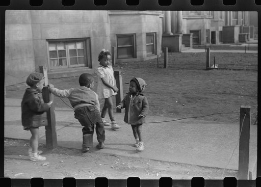 Untitled photo, possibly related to: Children in front of apartment buildings in one of the better neighborhoods in the Black Belt, Chicago, Illinois