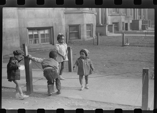 Children in front of apartment buildings in one of the better neighborhoods in the Black Belt, Chicago, Illinois