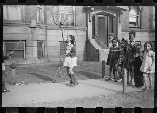 Untitled photo, possibly related to: Jumping rope on sidewalk in one of the better neighborhoods of the Black Belt, Chicago, Illinois