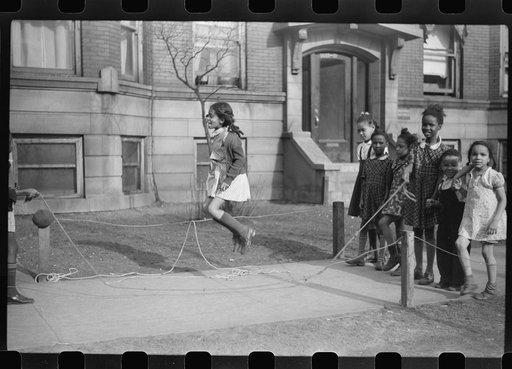 Untitled photo, possibly related to: Jumping rope on sidewalk in one of the better neighborhoods of the Black Belt, Chicago, Illinois