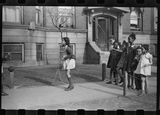 Untitled photo, possibly related to: Jumping rope on sidewalk in one of the better neighborhoods of the Black Belt, Chicago, Illinois