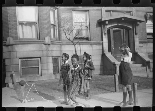 Untitled photo, possibly related to: Jumping rope on sidewalk in one of the better neighborhoods of the Black Belt, Chicago, Illinois