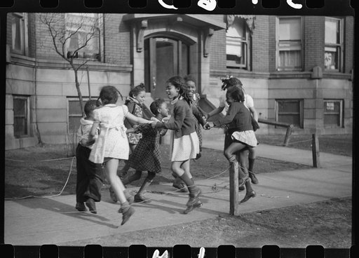Untitled photo, possibly related to: Jumping rope on sidewalk in one of the better neighborhoods of the Black Belt, Chicago, Illinois