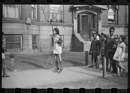Untitled photo, possibly related to: Jumping rope on sidewalk in one of the better neighborhoods of the Black Belt, Chicago, Illinois