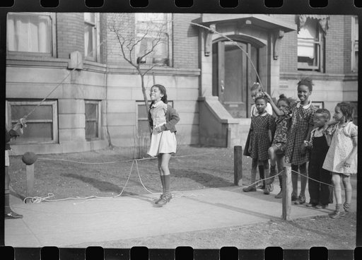 Jumping rope on sidewalk in one of the better neighborhoods of the Black Belt, Chicago, Illinois