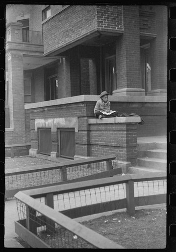 Child in front of apartment building in the better section of the Black Belt, Chicago, Illinois