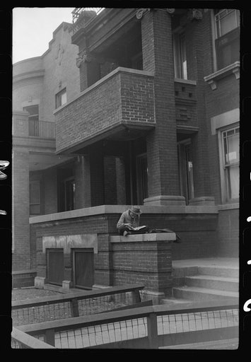 Untitled photo, possibly related to: Child in front of apartment building in the better section of the Black Belt, Chicago, Illinois