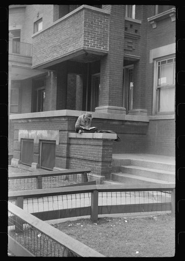 Untitled photo, possibly related to: Child in front of apartment building in the better section of the Black Belt, Chicago, Illinois